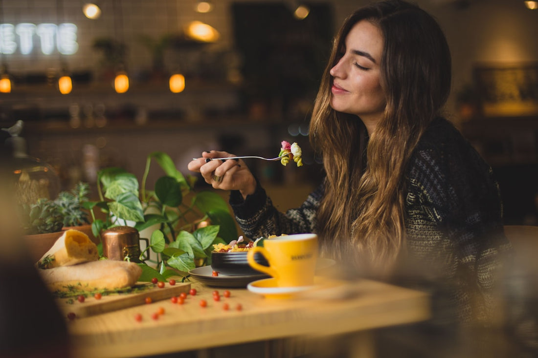 Woman at a table with a healthy meal