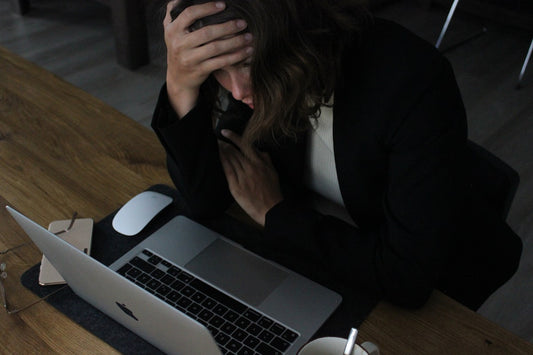 Professional woman at her desk representing chronic stress and cortisol elevation