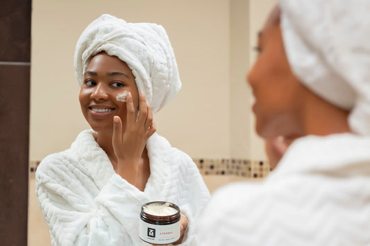 Woman applying skincare cream - hormonal skin care routine